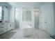 Modern bathroom with a freestanding tub, dual walk-in showers, vanity, and stylish tile flooring at 6953 Broglie St, Orlando, FL 32827