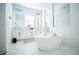 Modern bathroom featuring a soaking tub, dual vanities, and a glass-enclosed shower with marble tile at 6953 Broglie St, Orlando, FL 32827