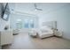 Serene main bedroom with a neutral color palette, hardwood floors, and a tray ceiling with fan at 6953 Broglie St, Orlando, FL 32827
