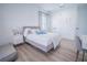 Bright bedroom featuring a plush bed, wood floors, and natural light at 6953 Broglie St, Orlando, FL 32827