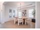 Bright dining room featuring modern light fixture, wood table, stylish chairs, and tray ceiling at 6953 Broglie St, Orlando, FL 32827