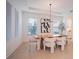 Bright dining room featuring modern light fixture, wood table, stylish chairs, and tray ceiling at 6953 Broglie St, Orlando, FL 32827