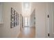 Bright foyer featuring a modern chandelier, light hardwood floors, and a collection of framed photos at 6953 Broglie St, Orlando, FL 32827
