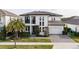 Charming two-story home with a well-manicured lawn, elegant landscaping, and an attached two-car garage at 6953 Broglie St, Orlando, FL 32827