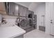 Modern laundry room featuring gray cabinets, stainless steel appliances and sink with light countertops at 6953 Broglie St, Orlando, FL 32827