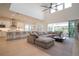 Open-concept living space with a large sectional sofa, modern kitchen, and access to the outdoor area at 6953 Broglie St, Orlando, FL 32827