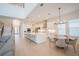 Spacious living area with a large kitchen, dining area, stairs, and bright natural light at 6953 Broglie St, Orlando, FL 32827
