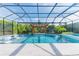 An enclosed pool with a jacuzzi and a seating area under a wooden pergola at 6953 Broglie St, Orlando, FL 32827