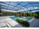 Enclosed pool with jacuzzi, sun loungers, and a covered seating area under a pergola at 6953 Broglie St, Orlando, FL 32827
