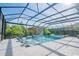 Enclosed pool with jacuzzi, sun loungers, and a covered seating area under a pergola at 6953 Broglie St, Orlando, FL 32827
