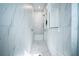 Luxurious marble tiled shower with a bench seat and a glass door at 6953 Broglie St, Orlando, FL 32827