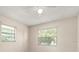 Neutral bedroom featuring two windows for natural light and a ceiling fan at 704 Michigan Ct # 4, St Cloud, FL 34769