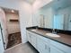 Bathroom featuring double vanity and entrance to a walk-in closet at 8023 Sayings Dr, Winter Garden, FL 34787