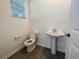 Powder room featuring a pedestal sink and modern fixtures for a sleek and functional design at 8023 Sayings Dr, Winter Garden, FL 34787