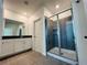 Bathroom featuring double vanity and large shower with gray tile surround at 8023 Sayings Dr, Winter Garden, FL 34787