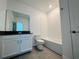 Bathroom featuring vanity with dark countertop, toilet, and tub with white tile surround at 8023 Sayings Dr, Winter Garden, FL 34787