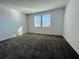 Bedroom featuring carpet, white walls and dual windows with a view of the outdoors at 8023 Sayings Dr, Winter Garden, FL 34787