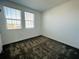 Bright bedroom featuring two large windows, neutral walls, and plush carpeting at 8023 Sayings Dr, Winter Garden, FL 34787