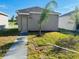 Exterior view of back of house with small tree in the front yard at 8023 Sayings Dr, Winter Garden, FL 34787