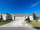 Driveway leading to a home featuring a large garage with an automatic door at 8023 Sayings Dr, Winter Garden, FL 34787