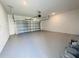 Spacious garage featuring epoxy flooring and an automatic door at 8023 Sayings Dr, Winter Garden, FL 34787