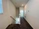 Upstairs hallway with carpeted floors and view to the downstairs and another room at 8023 Sayings Dr, Winter Garden, FL 34787