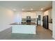 Open kitchen featuring a large island, stainless appliances, and ample counter space for meal preparation at 8023 Sayings Dr, Winter Garden, FL 34787