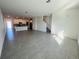 Expansive living area with neutral tones, tile flooring, and seamless flow into the modern kitchen at 8023 Sayings Dr, Winter Garden, FL 34787