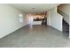 Bright, open-concept living space with tile floors, adjacent to the modern kitchen and staircase at 8023 Sayings Dr, Winter Garden, FL 34787