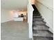 Open floor plan showcasing the kitchen and staircase creating a seamless flow for modern living at 8023 Sayings Dr, Winter Garden, FL 34787