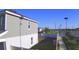 View of the house and neighborhood from the backyard with a white fence and green grass at 804 Timberland Dr, Eagle Lake, FL 33839
