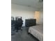 Carpeted bedroom with modern style desk and natural light from the windows at 804 Timberland Dr, Eagle Lake, FL 33839