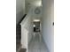 Bright foyer with tile flooring, staircase, and a view into a living area with a clock on the wall at 804 Timberland Dr, Eagle Lake, FL 33839