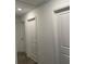 Hallway with multiple doors showcasing access to different areas of the home at 804 Timberland Dr, Eagle Lake, FL 33839