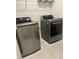 Laundry room featuring a front-load washer and dryer set, and storage shelf at 804 Timberland Dr, Eagle Lake, FL 33839