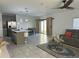 Open-concept living area with gray sofa, modern ceiling fan, and sliding barn doors leading to the backyard at 804 Timberland Dr, Eagle Lake, FL 33839