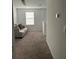 Cozy carpeted sitting area with comfortable sofa, window, and plenty of natural light at 804 Timberland Dr, Eagle Lake, FL 33839