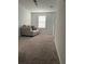 Cozy carpeted sitting area with comfortable sofa, window, and plenty of natural light at 804 Timberland Dr, Eagle Lake, FL 33839