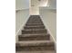 Carpeted staircase with white railing leading to the upper level of the home at 804 Timberland Dr, Eagle Lake, FL 33839