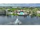Waterfront community featuring a pool, clubhouse, and surrounding lake with a fountain at 8374 Quimby Cir # 8374, Davenport, FL 33896