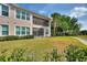 The backyard has a screened lanai, fenced-in lawn, and partial view of surrounding greenery at 8374 Quimby Cir # 8374, Davenport, FL 33896