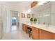 Bright bathroom featuring double sinks, tile flooring, and a glass-enclosed shower creating a clean, modern space at 8374 Quimby Cir # 8374, Davenport, FL 33896
