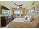 Relaxing bedroom with a flat screen TV, a large window, and plenty of sunlight at 8374 Quimby Cir # 8374, Davenport, FL 33896