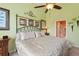 Calm bedroom with green walls, a decorative metal bed, and unique wall decor at 8374 Quimby Cir # 8374, Davenport, FL 33896