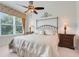 Comfortable bedroom featuring a ceiling fan, large window, and neutral color palette creating a relaxing atmosphere at 8374 Quimby Cir # 8374, Davenport, FL 33896