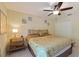 Warm bedroom with neutral walls, ceiling fan, and a decorative bed with patterned bedding at 8374 Quimby Cir # 8374, Davenport, FL 33896