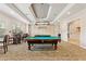 Well-lit billiard room with pool tables, seating, and decorative lighting fixtures at 8374 Quimby Cir # 8374, Davenport, FL 33896
