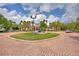 Circular driveway with fountain in front of community center on sunny day with tropical landscaping at 8374 Quimby Cir # 8374, Davenport, FL 33896