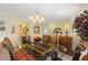 Formal dining room featuring a glass table, decorative chandelier, and stylish buffet at 8374 Quimby Cir # 8374, Davenport, FL 33896