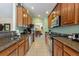 Well-lit kitchen with granite counters, stainless steel appliances, and tile flooring at 8374 Quimby Cir # 8374, Davenport, FL 33896